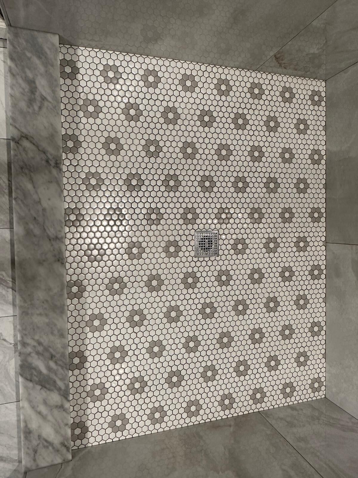 White and gray hexagon mosaic shower floor in a flower pattern