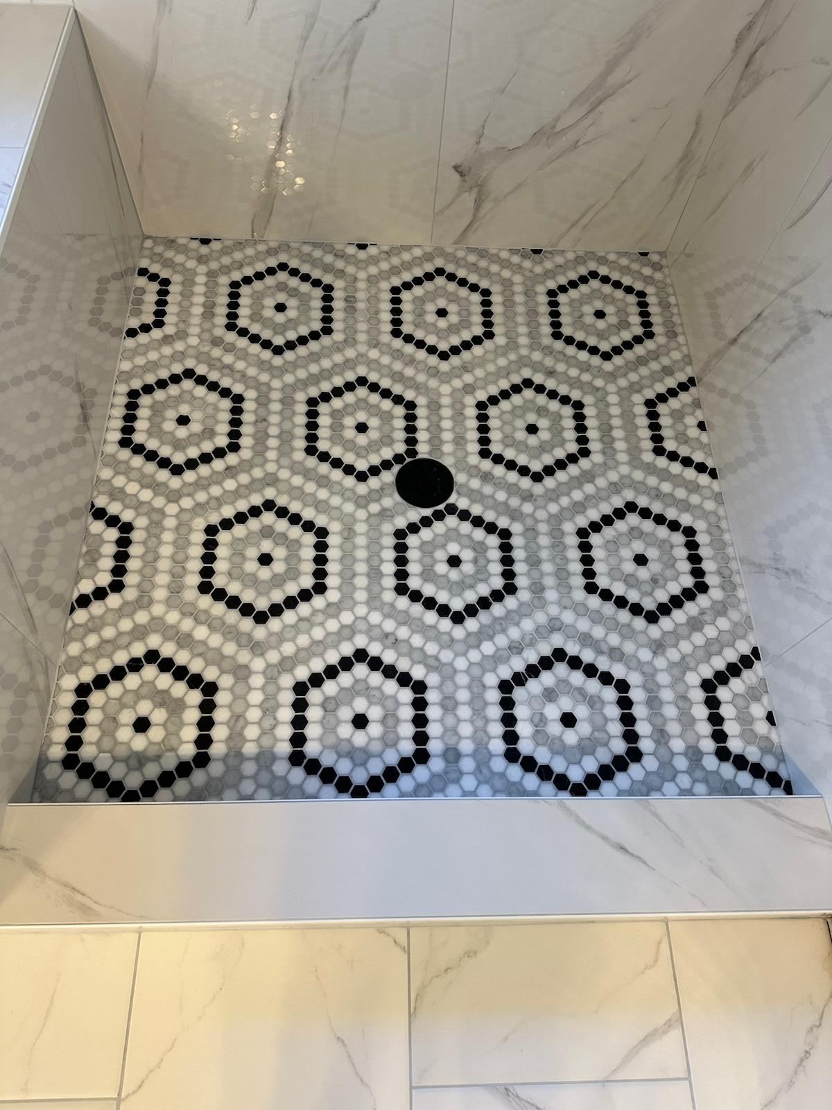 Black and white hexagon mosaic shower floor detail