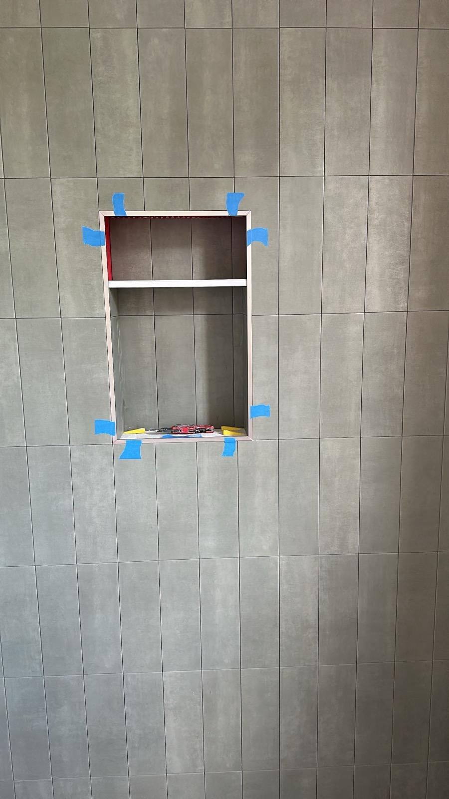 Shower walls set with tile leveling clip system before grouting